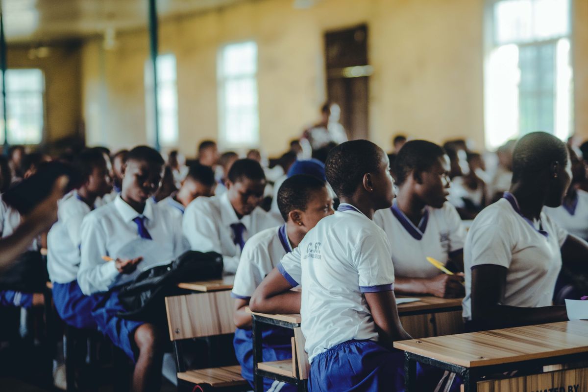 Students seated together in a school assembly hall