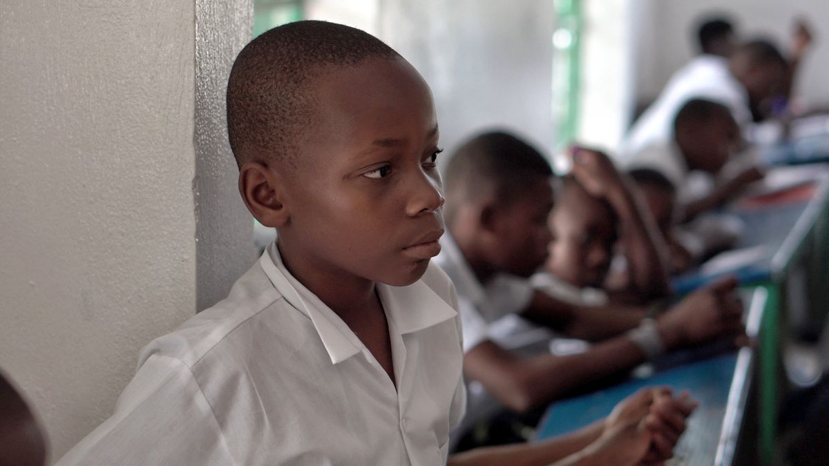 A young student in a primary school classroom